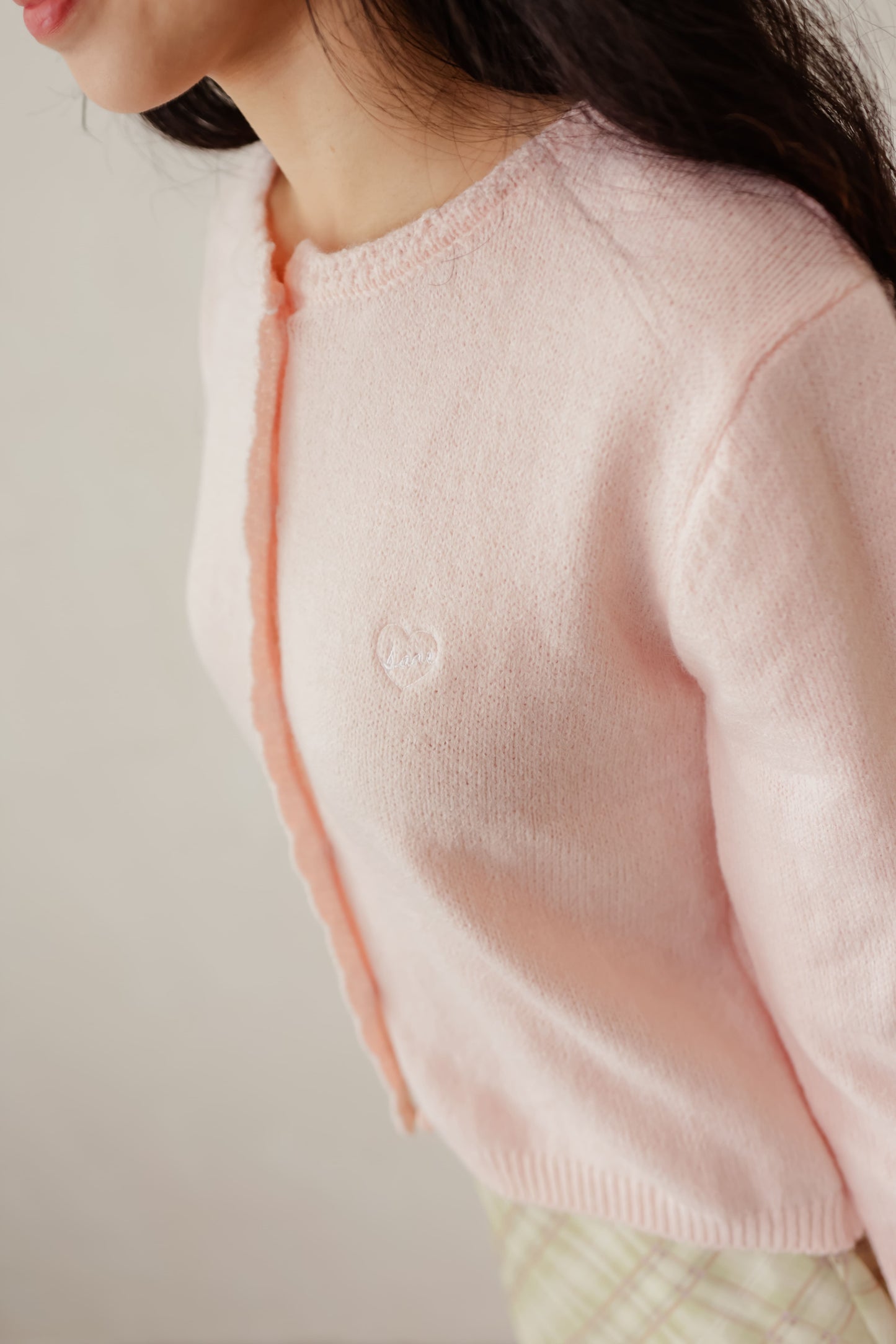 Pink Candy cardigan with soft knit texture and contrast buttons – playful layering piece for everyday wear
